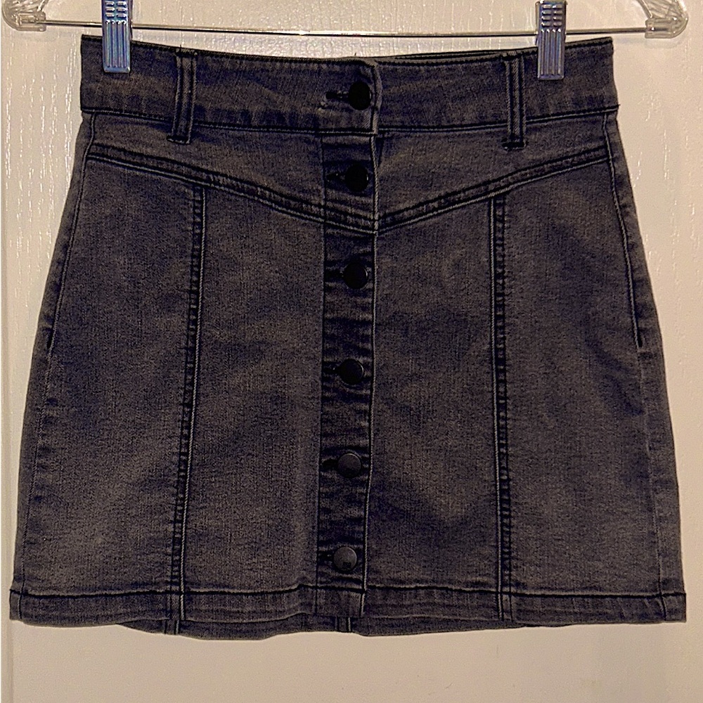 Chic & sleek denim mini skirt. Button up front adds a cool vintage vibe.